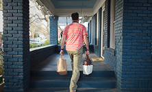Person Carrying Grocery Bags Home